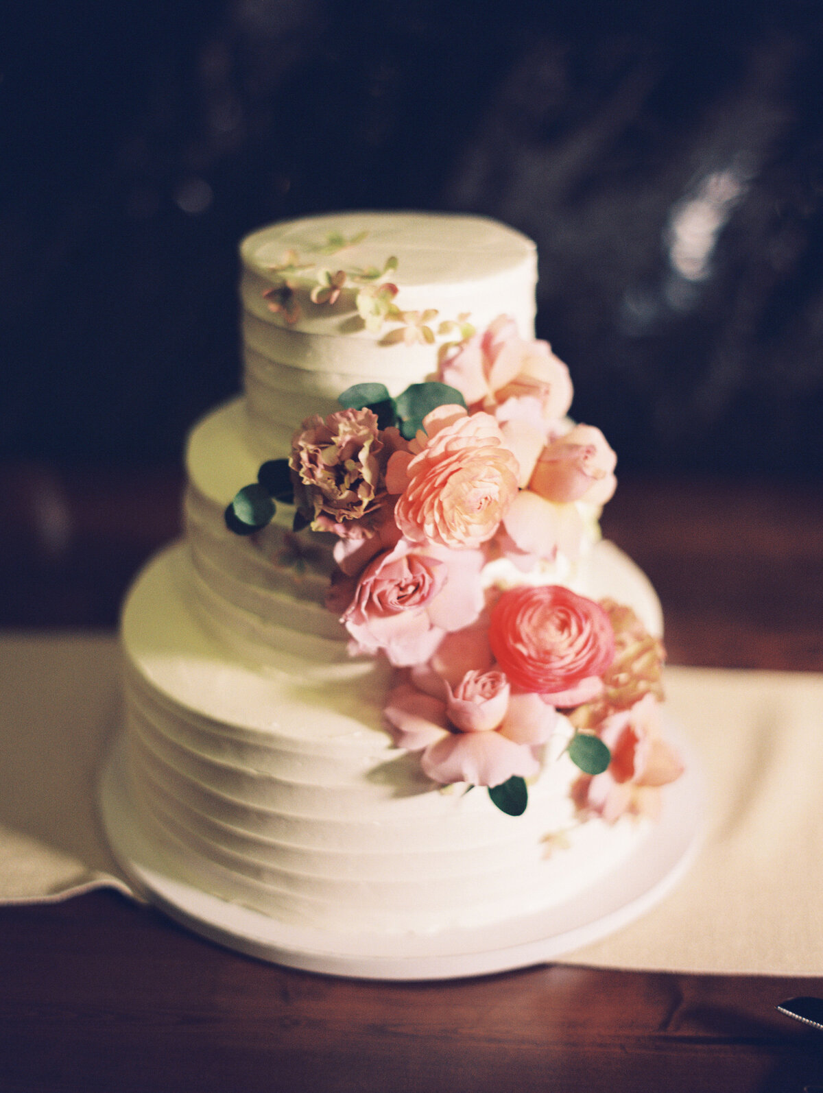 3 tiered wedding cake with florals for wedding at The Inn at Burklyn