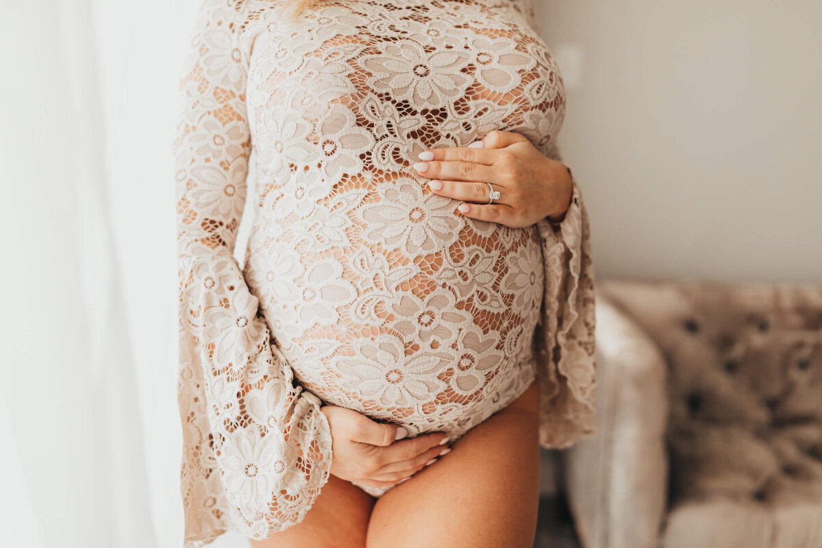 belly shot with mom wearing a boho lace bodysuit