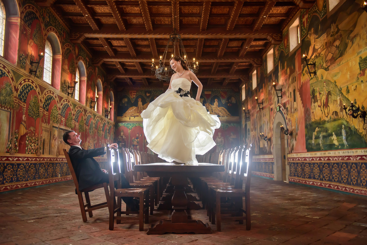 Bride dancing on table at Castello di Amorosa