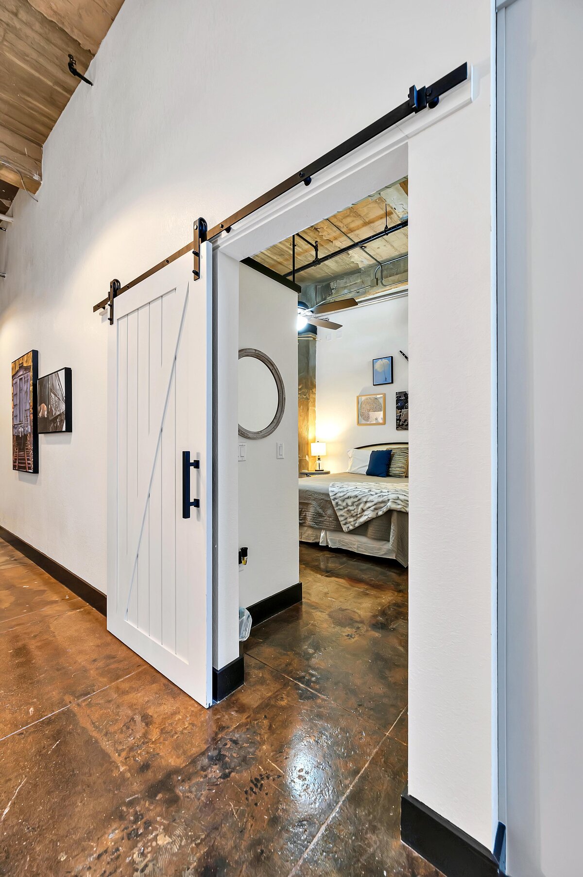 Beautiful sliding barn door attached to bedroom in this one-bedroom, one-bathroom vintage industrial condo with Smart TV, free Wi-Fi, and washer/dryer located in downtown Waco, TX.