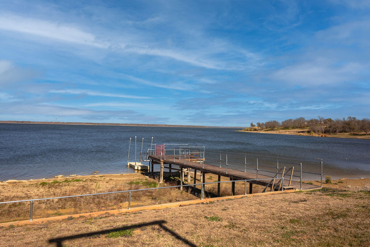 Access to a fishing dock and boat loading area on Tradinghouse Lake at this 2-bedroom, 2-bathroom lakeside vacation rental home for 6 guests on Tradinghouse Lake with privacy access to a fishing dock and boat launch pad, ping pong table, gazebo, free wifi and free parking in Waco, TX.