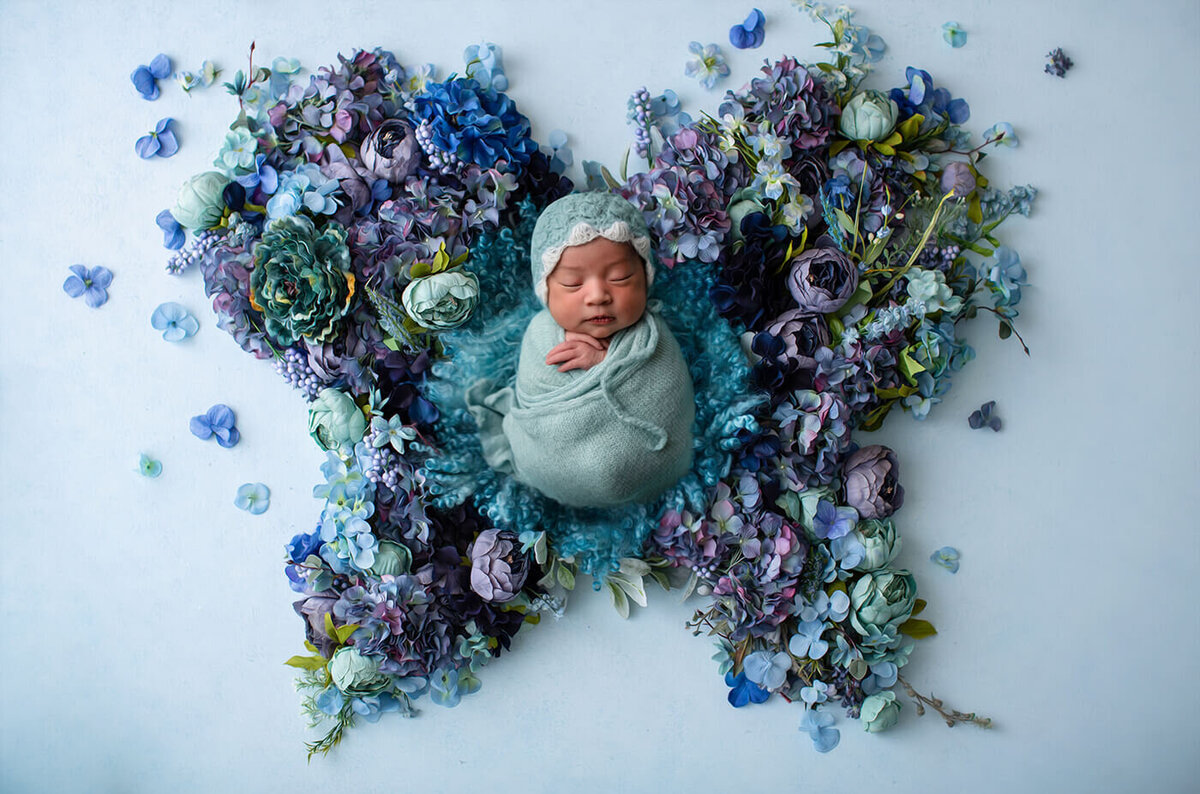 Newborn Baby as a Blue Butterfly