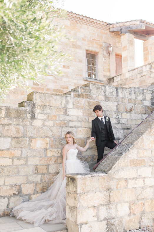 bride and groom walking up stairs at Sunstone Winery