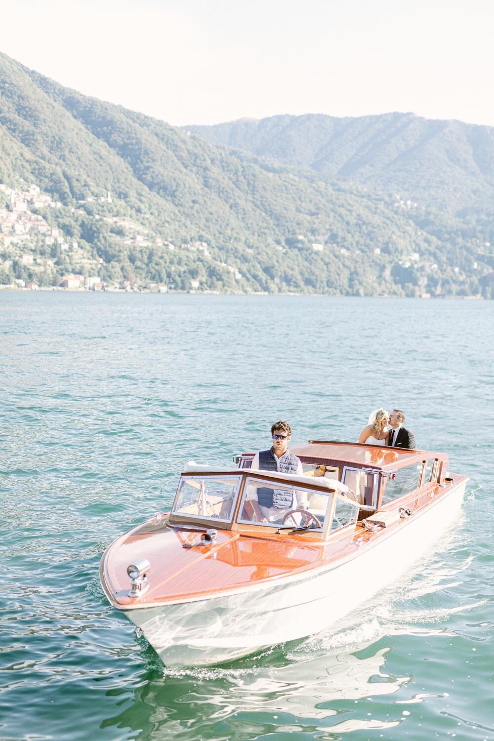 bride and groom on the boat ride around lake como