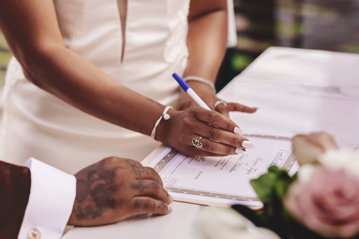 Bride signing wedding certificate at wedding in Cancun