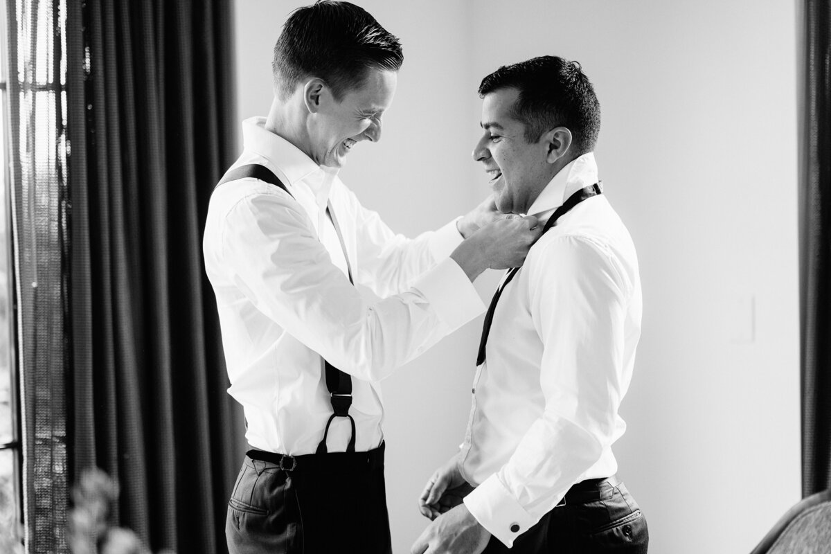 Grooms helping each other get ready