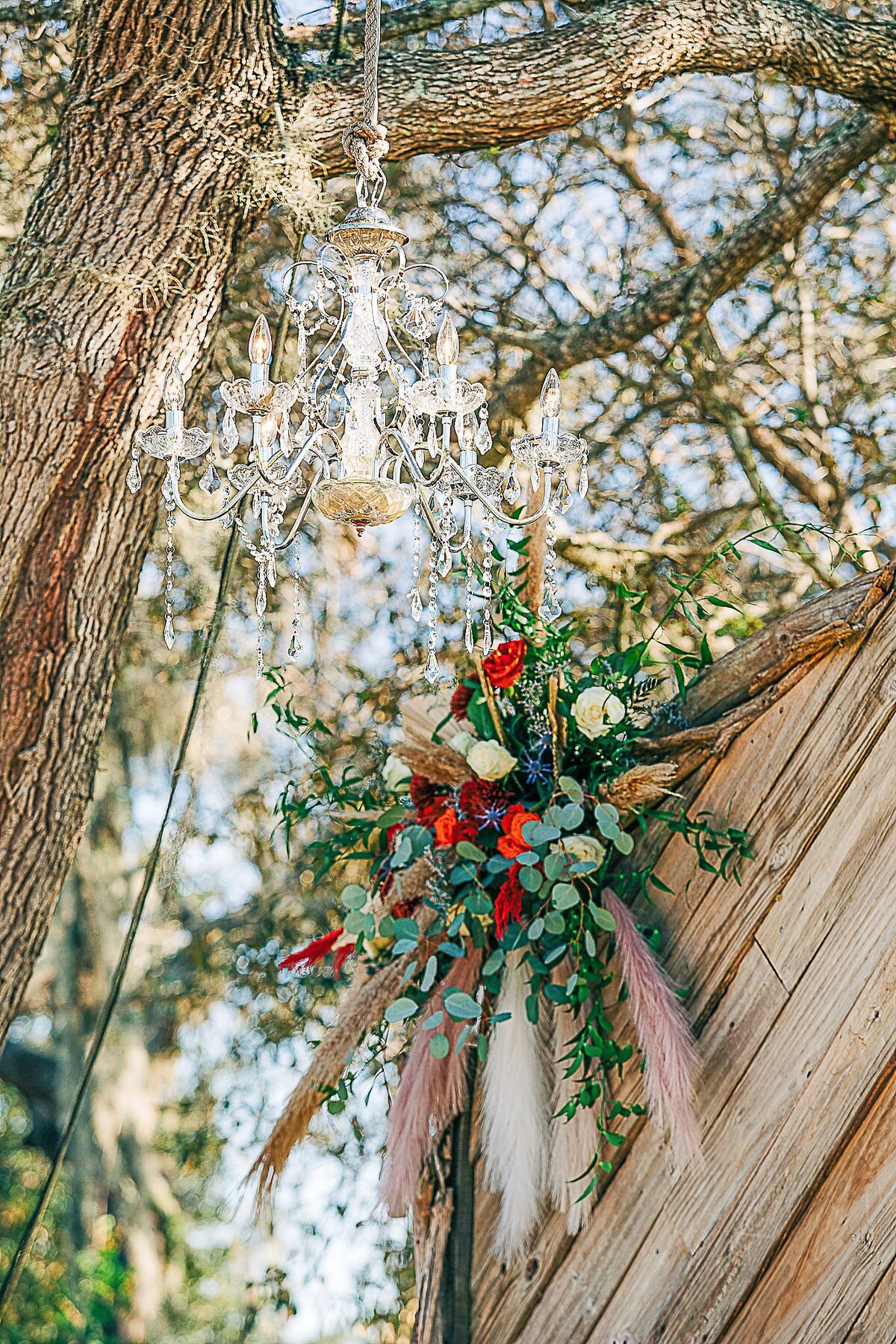 flowers and chandelier decorate Bending Branch Ranch ceremony