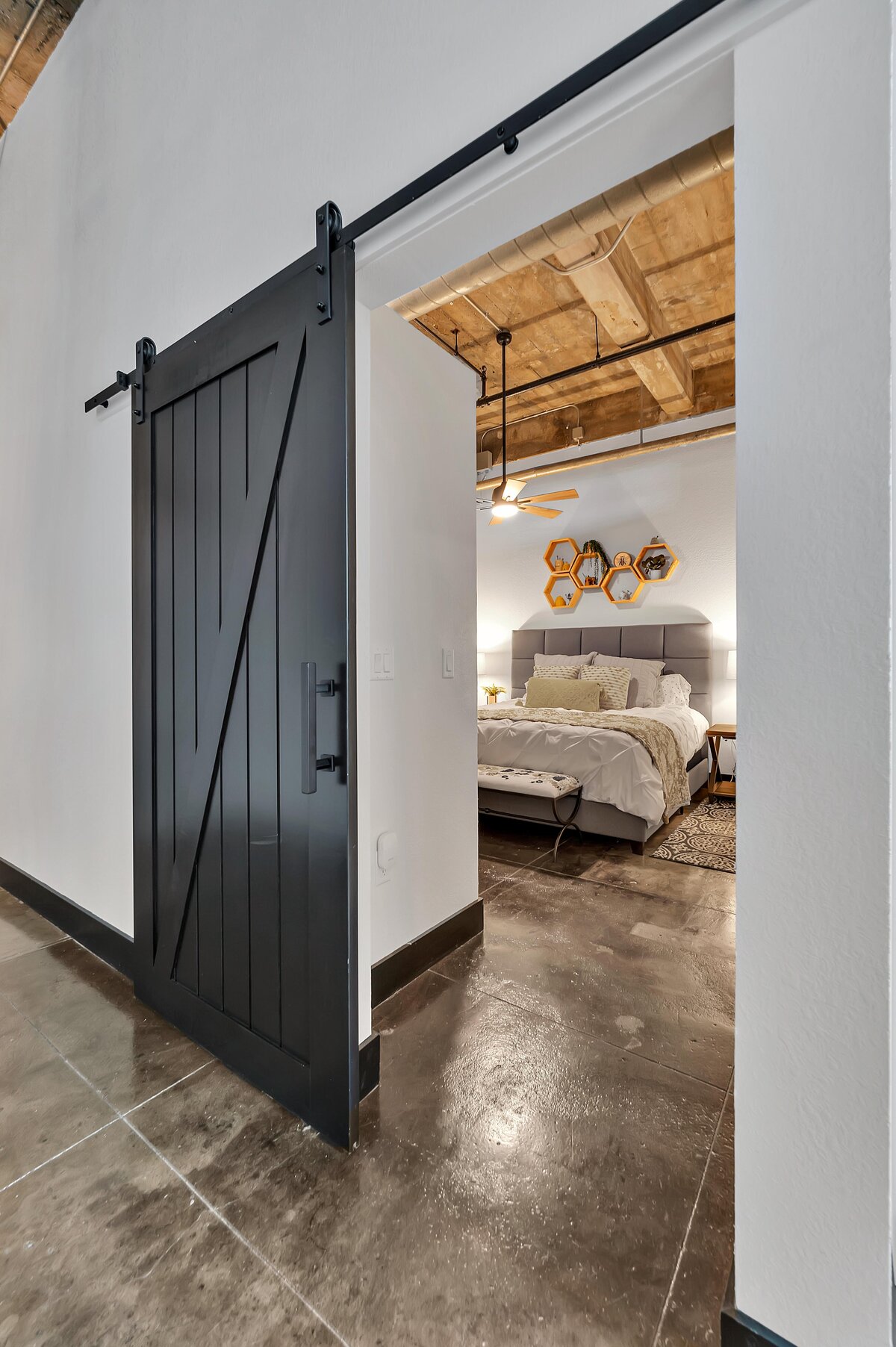 View of the master bedroom in this one-bedroom, one-bathroom vintage condo that sleeps 4 in the historic Behrens building in the heart of the Magnolia Silo District in downtown Waco, TX.