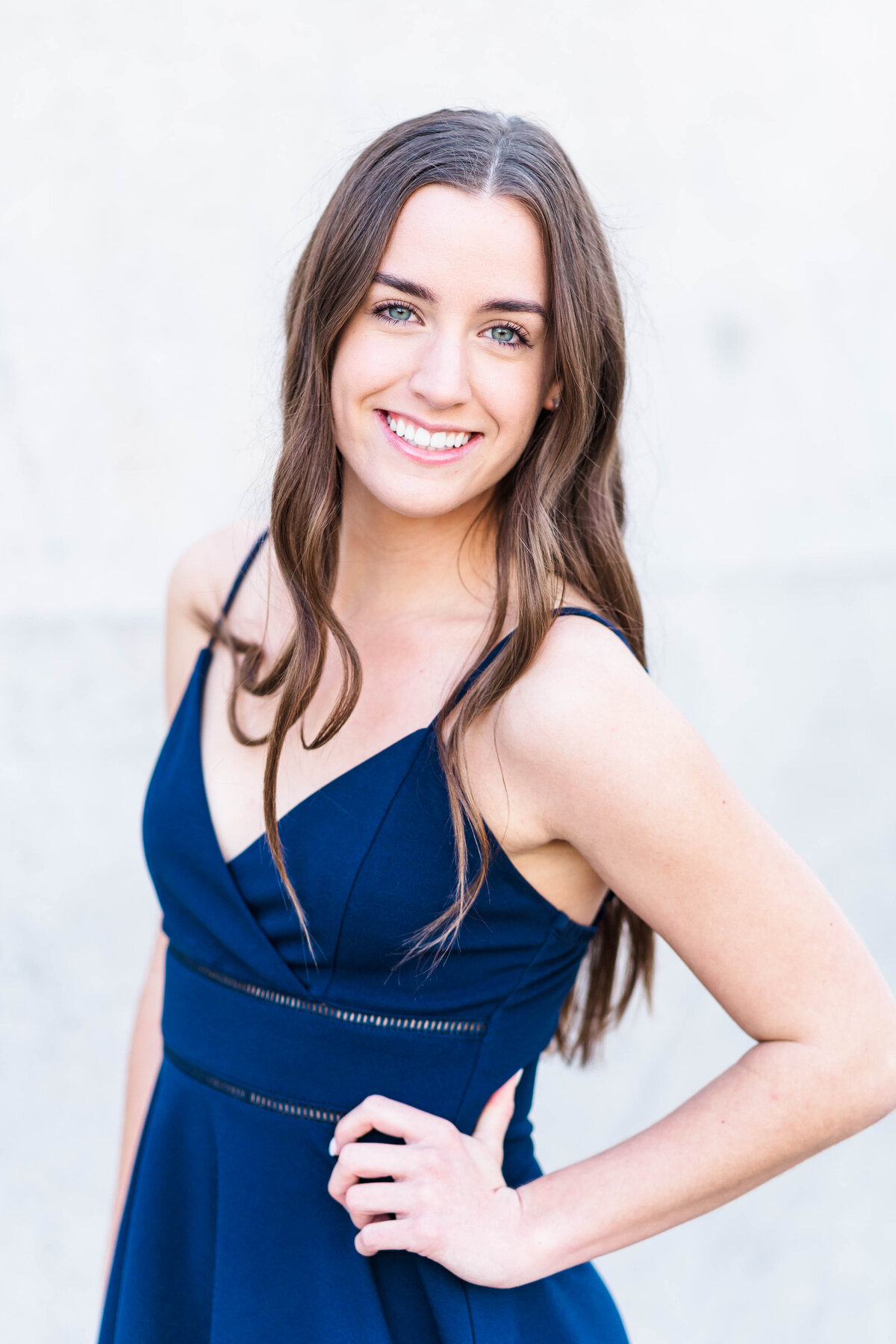 Girl in blue dress smiling at camera