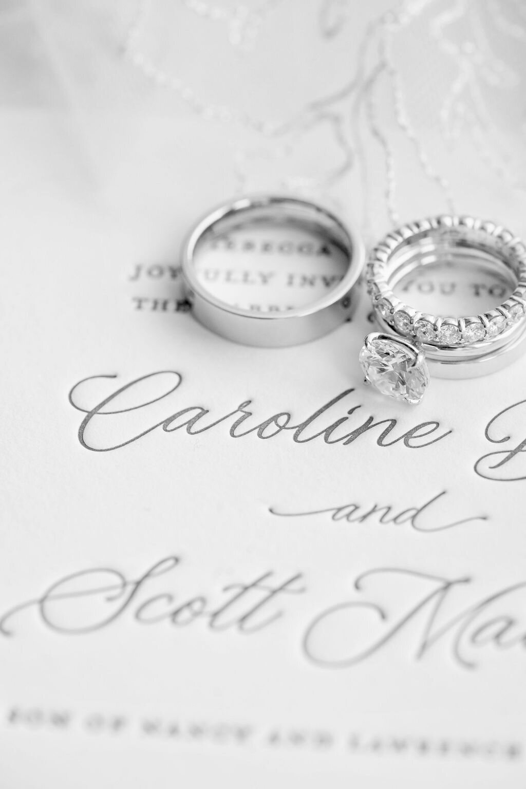 wedding rings with engagement ring on invitation suite