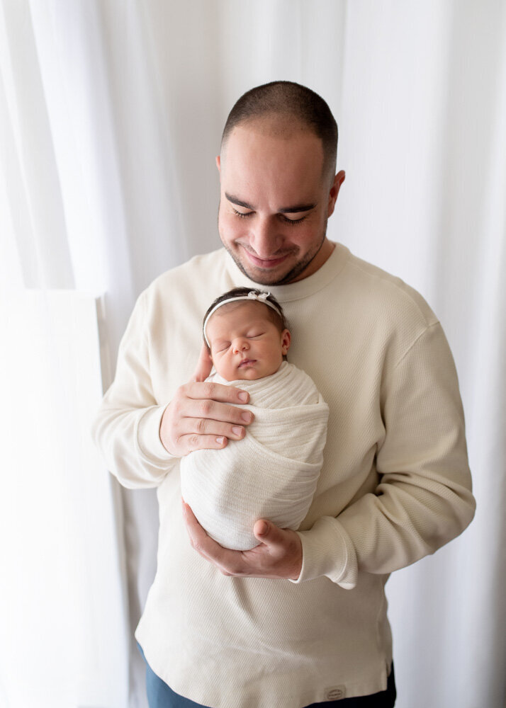 Newborn session of baby girl with father