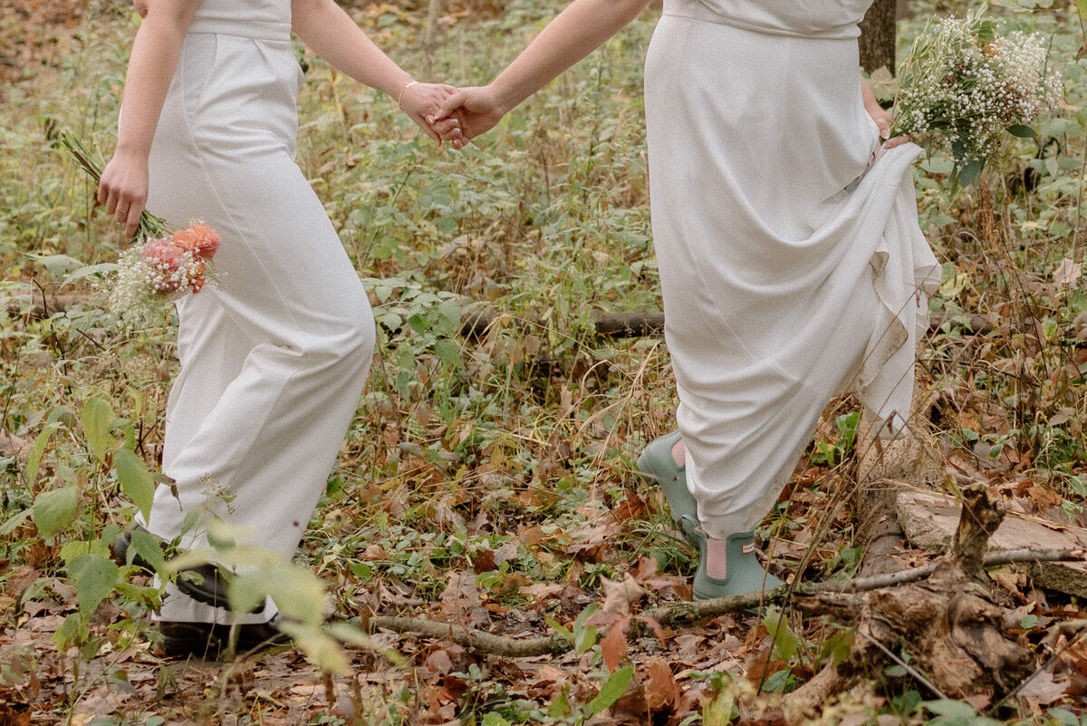 brides walk together in forest