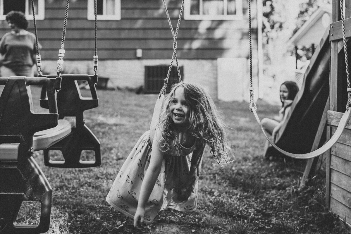Backyard family photography session with girl on swing in Chattanooga, TN