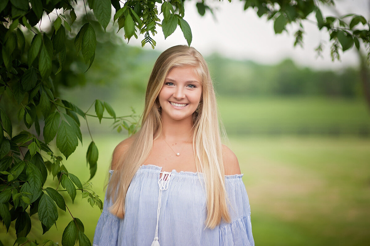 Senior session of young woman near tree