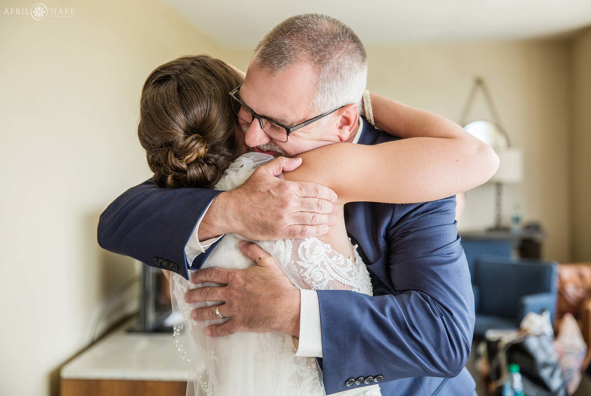 Bride has a first look moment with her dad on her Denver area wedding day