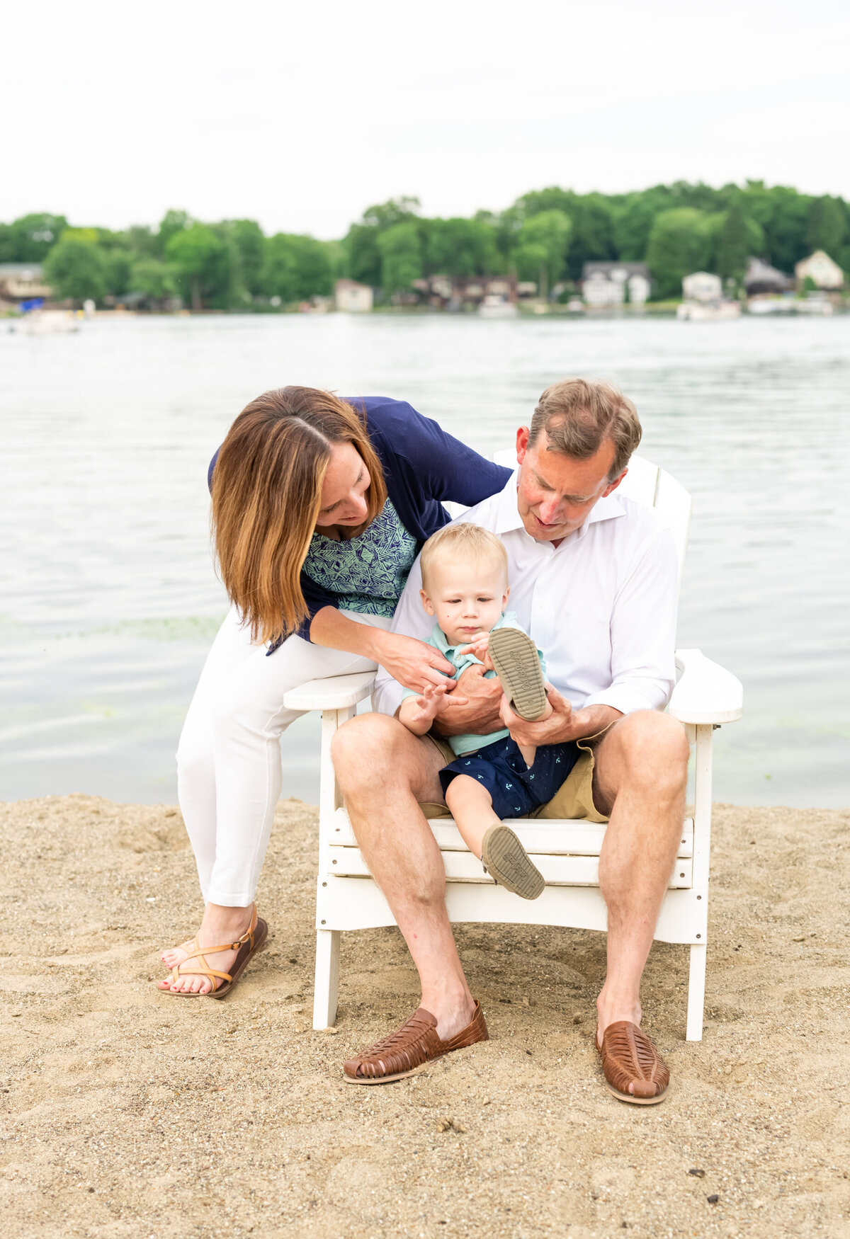 mom and dad with toddler boy on beach