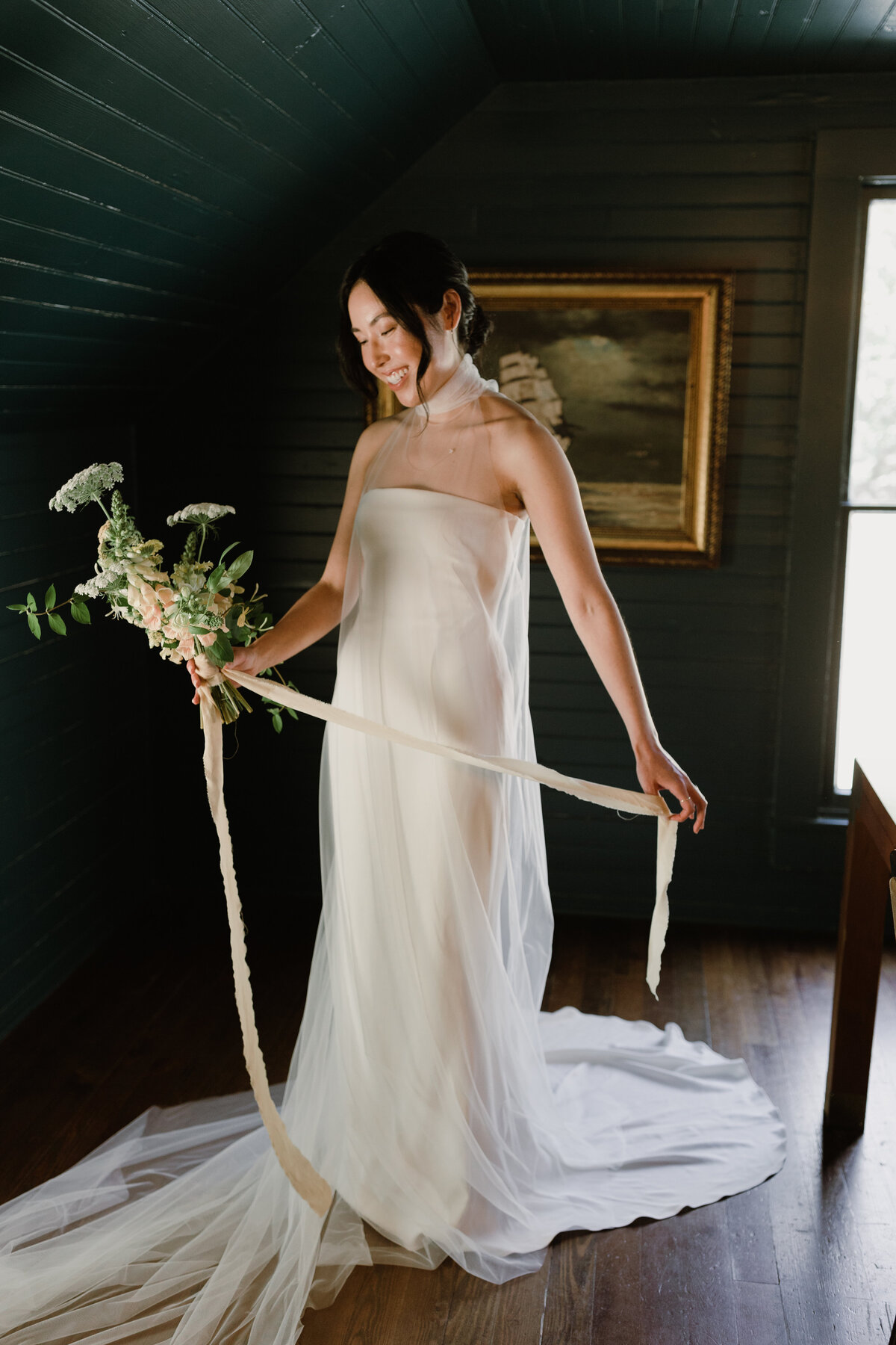 Bride holding bouquet with long ribbon at Mattie's wedding venue in Austin