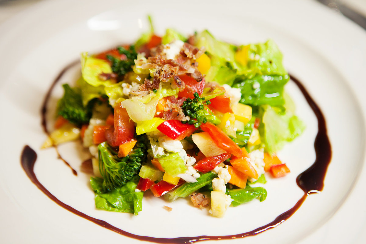 Vizcaya Chop Salad seasonal vegetables, shaft blue cheese, bacon, & balsamic vinaigrette.
