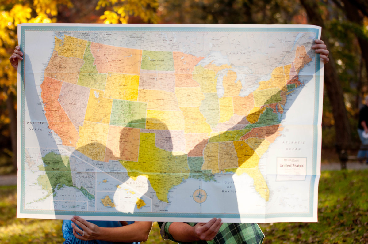 couple with map for engagement photos