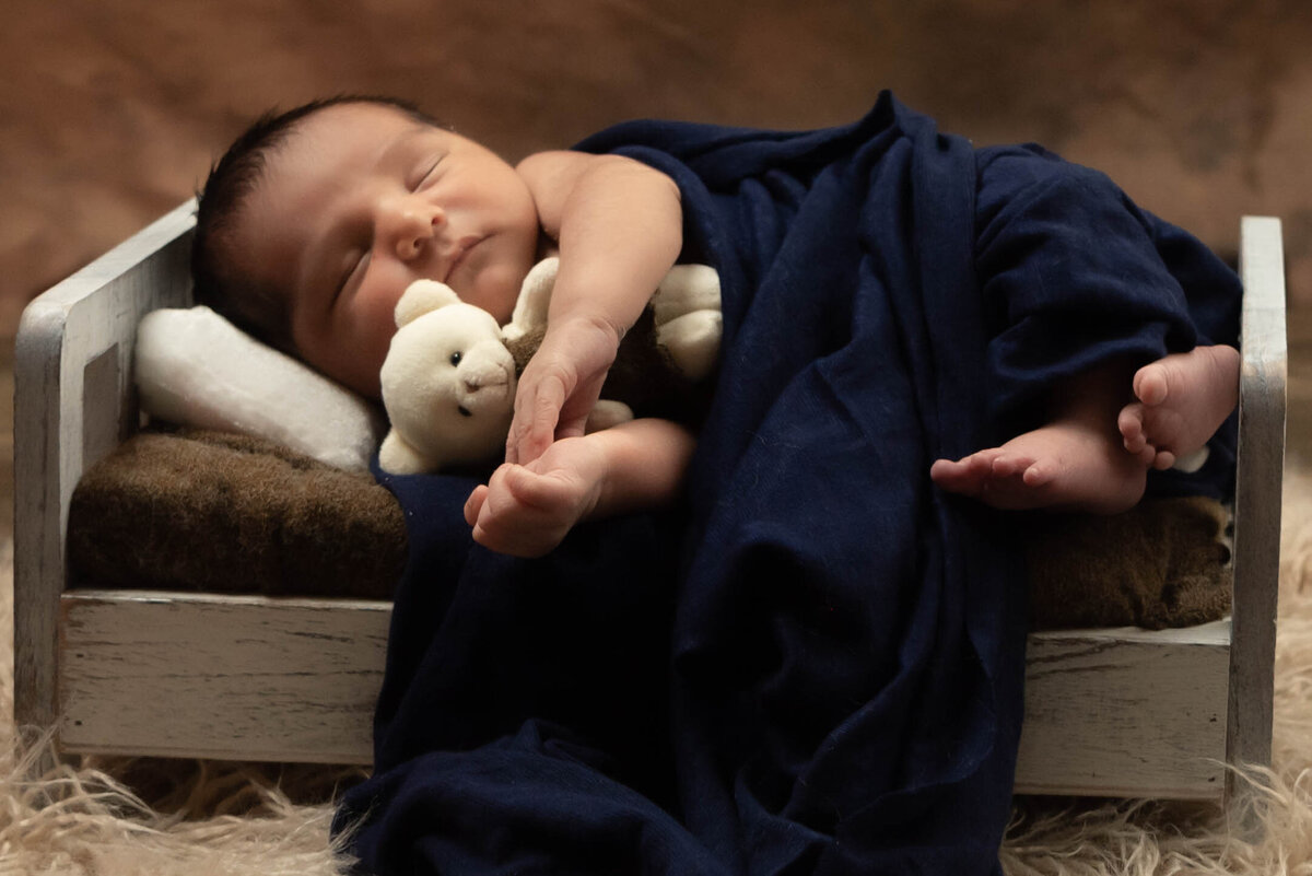 Newborn baby cozy in a manger for a quick nap