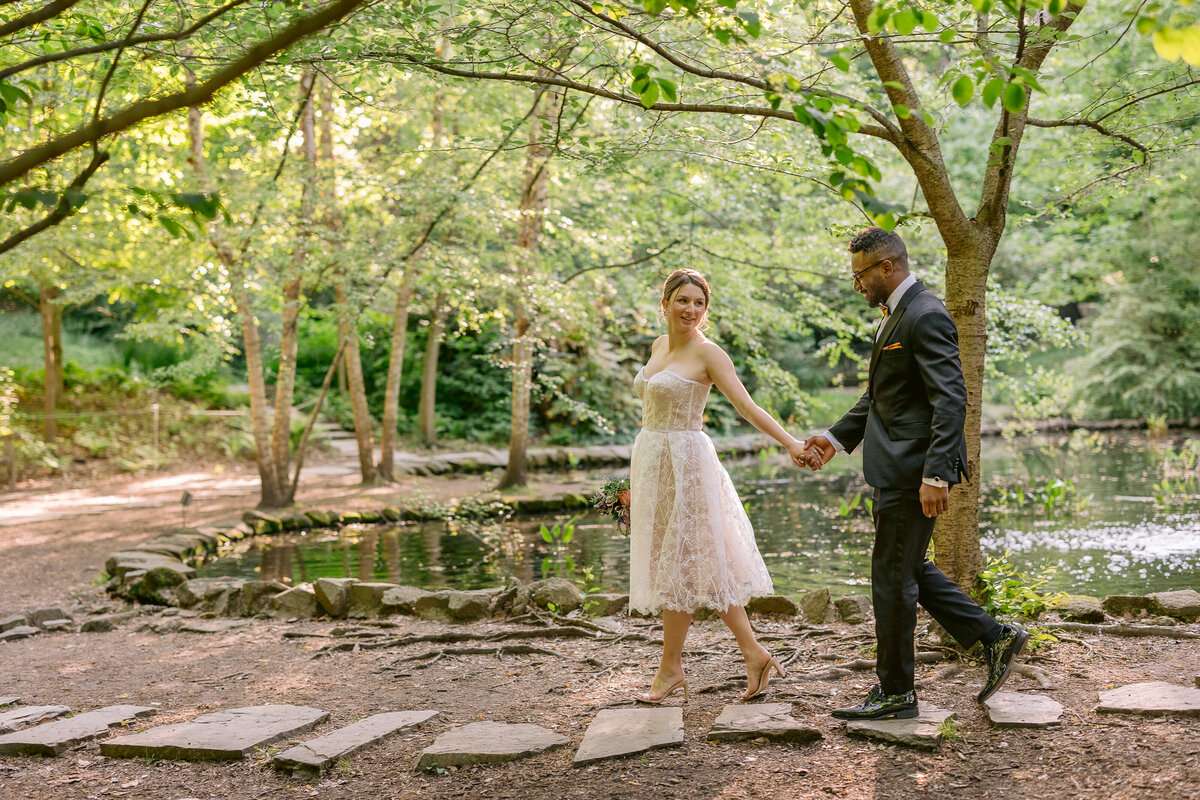 Wedding Photographer, a couple holding hands in a garden