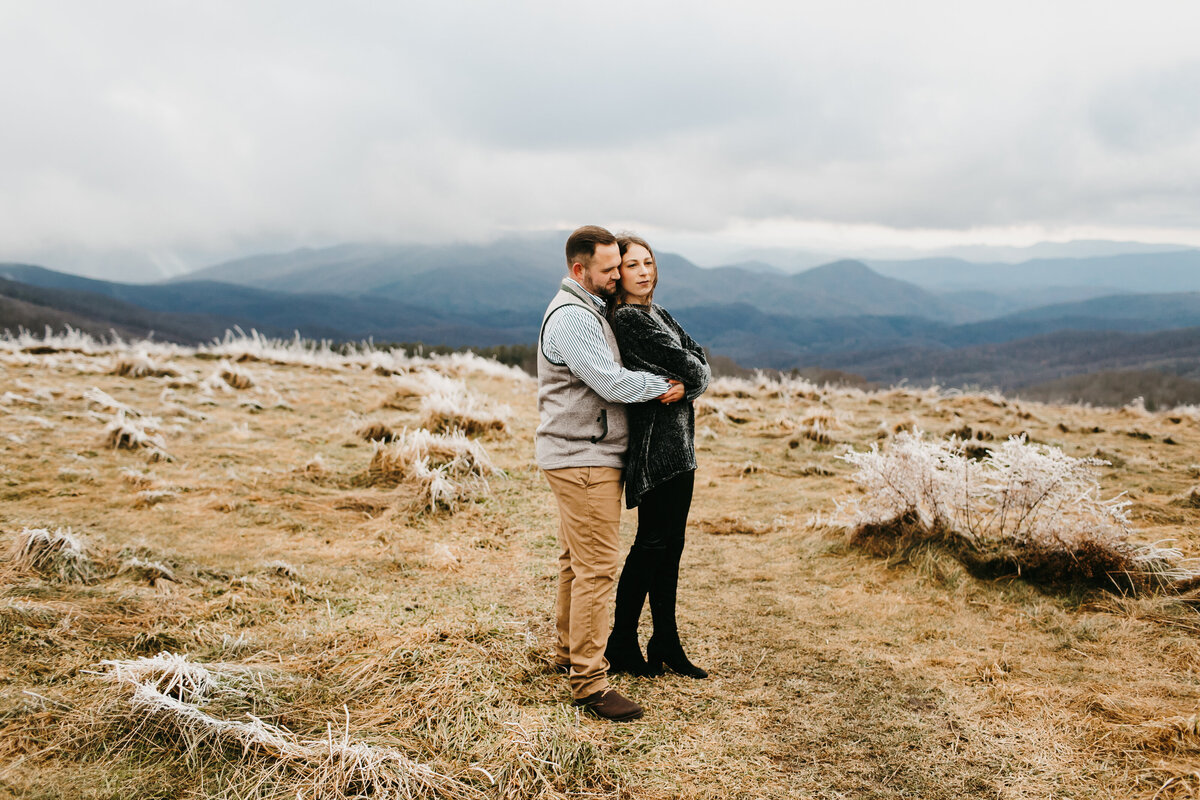 couple holding each other on mountain top Max Patch Blue Ridge Mountains