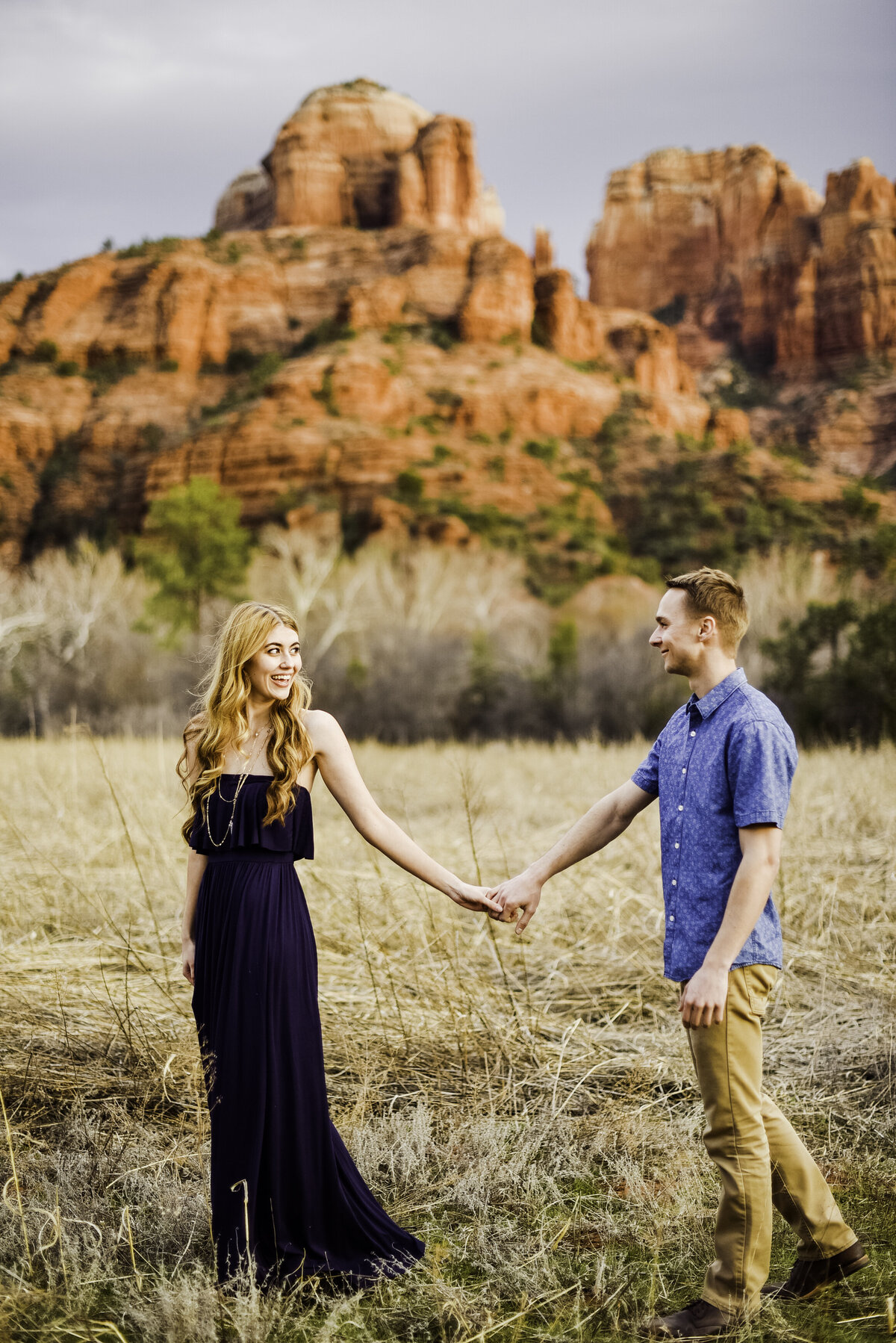 Engaged couple walking together Crescent Moon Ranch Sedona Cathedral Rock