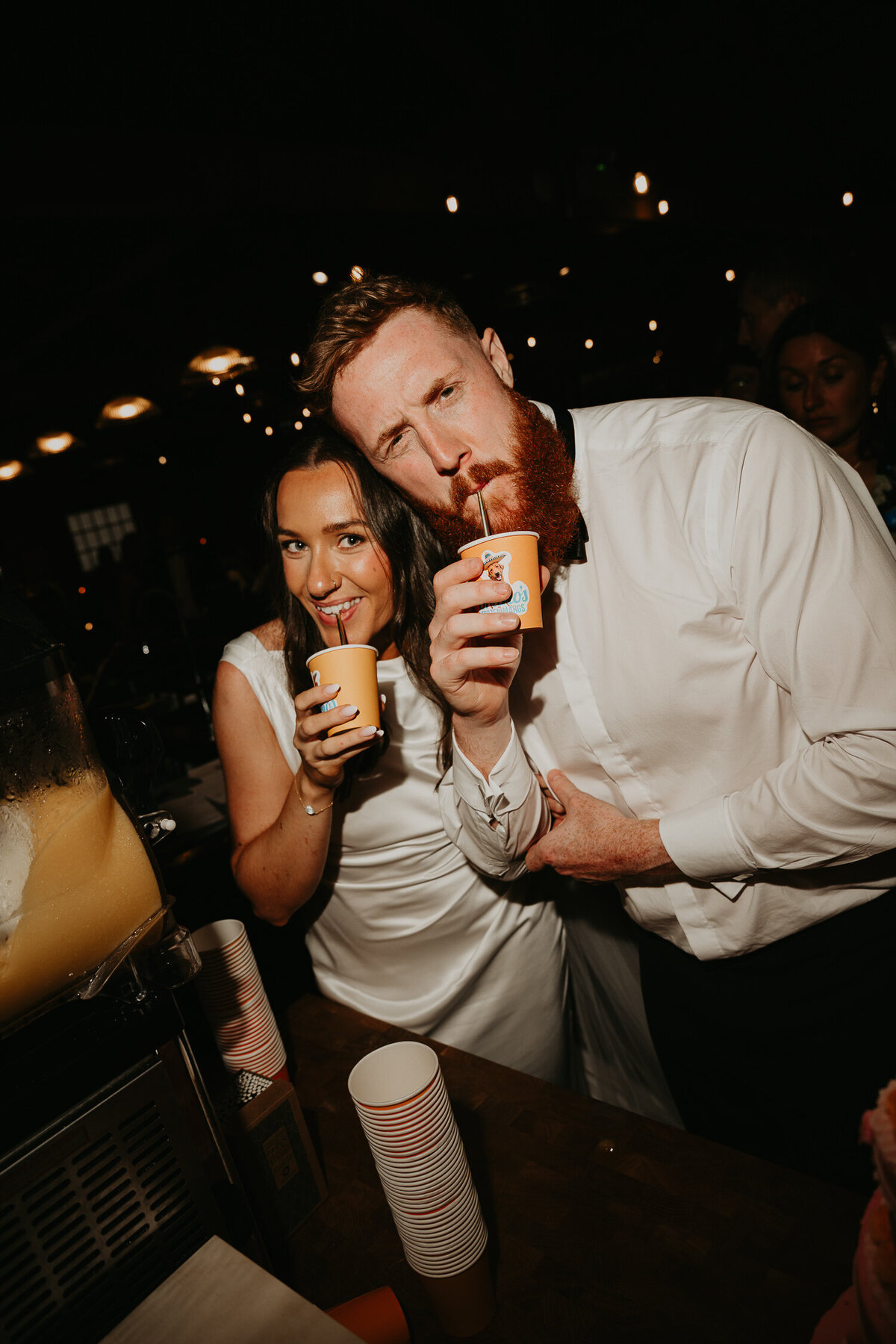 Bride and groom drinking at their wedding reception at The Stables in Manchester. 