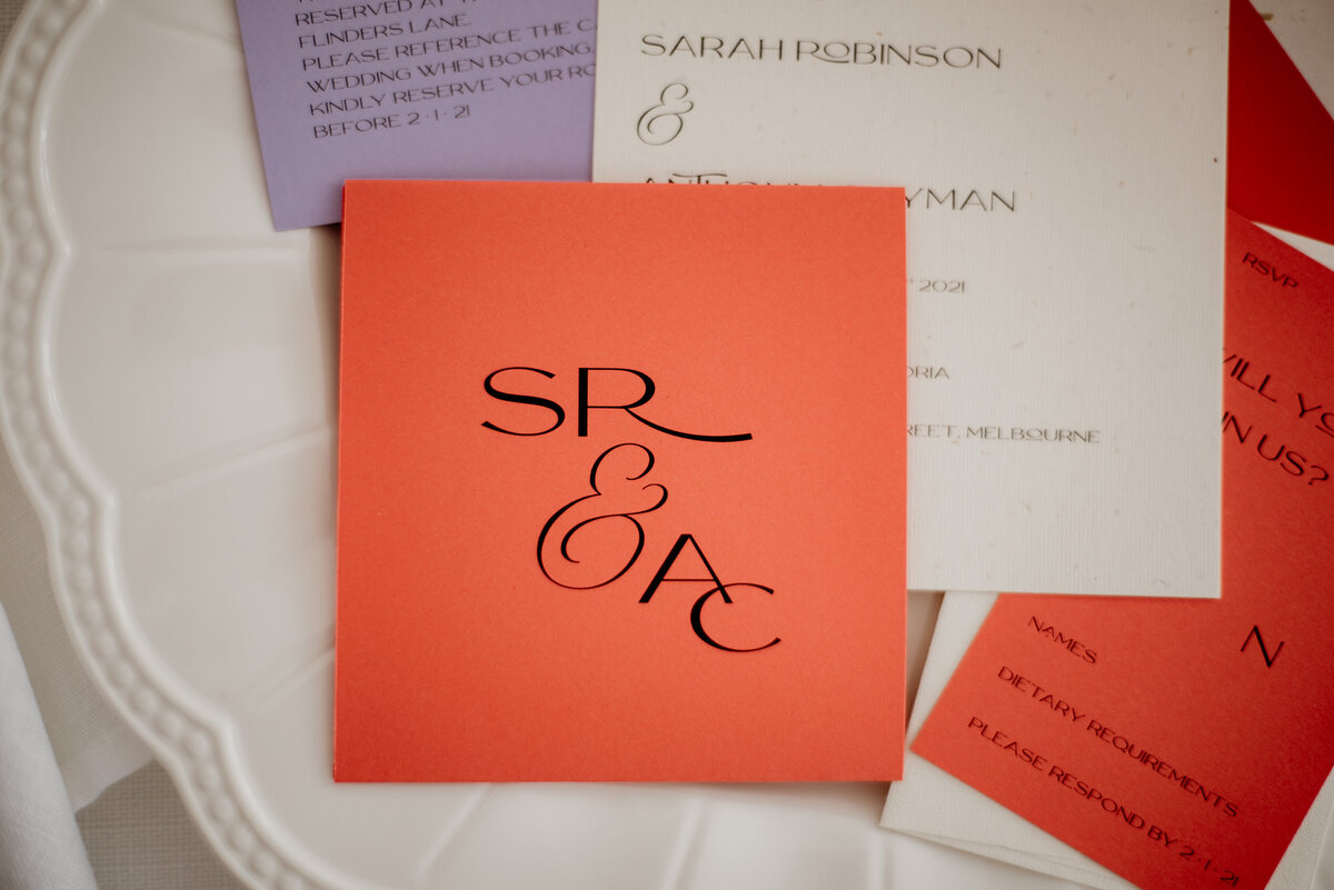 Orange wedding invitation with contemporary monogram