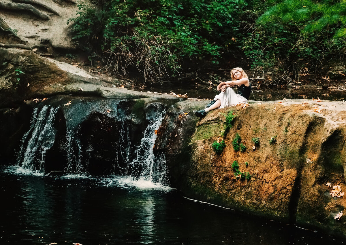 Senior girl next to waterfall