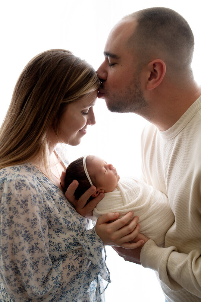 Newborn session of baby girl with mother and father