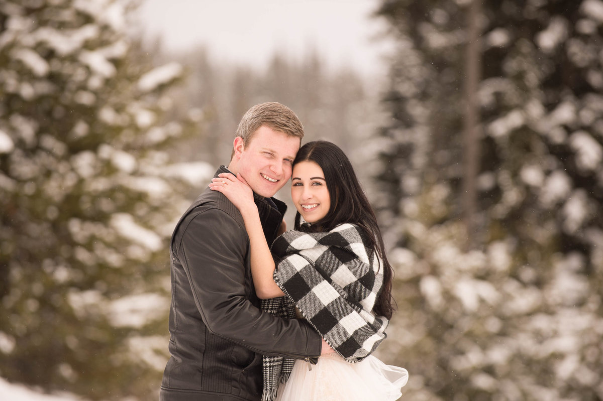 Beautiful Big White ski hill resort engagement photos in the snow while snowing