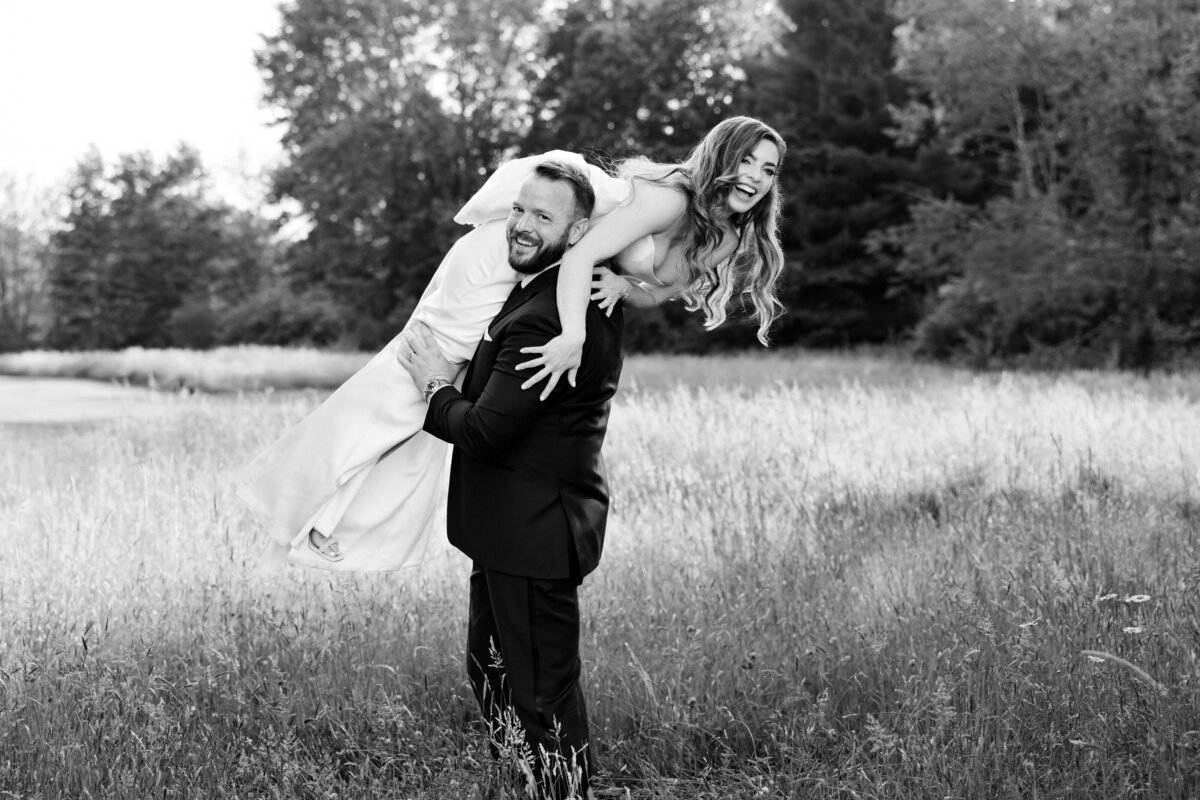 a bride and groom embrace one another during their couples portraits on their wedding day in Ohio. A true love story. Friends of more than 20 years before dating. And now finally happily married! Photo taken by Aaron Aldhizer