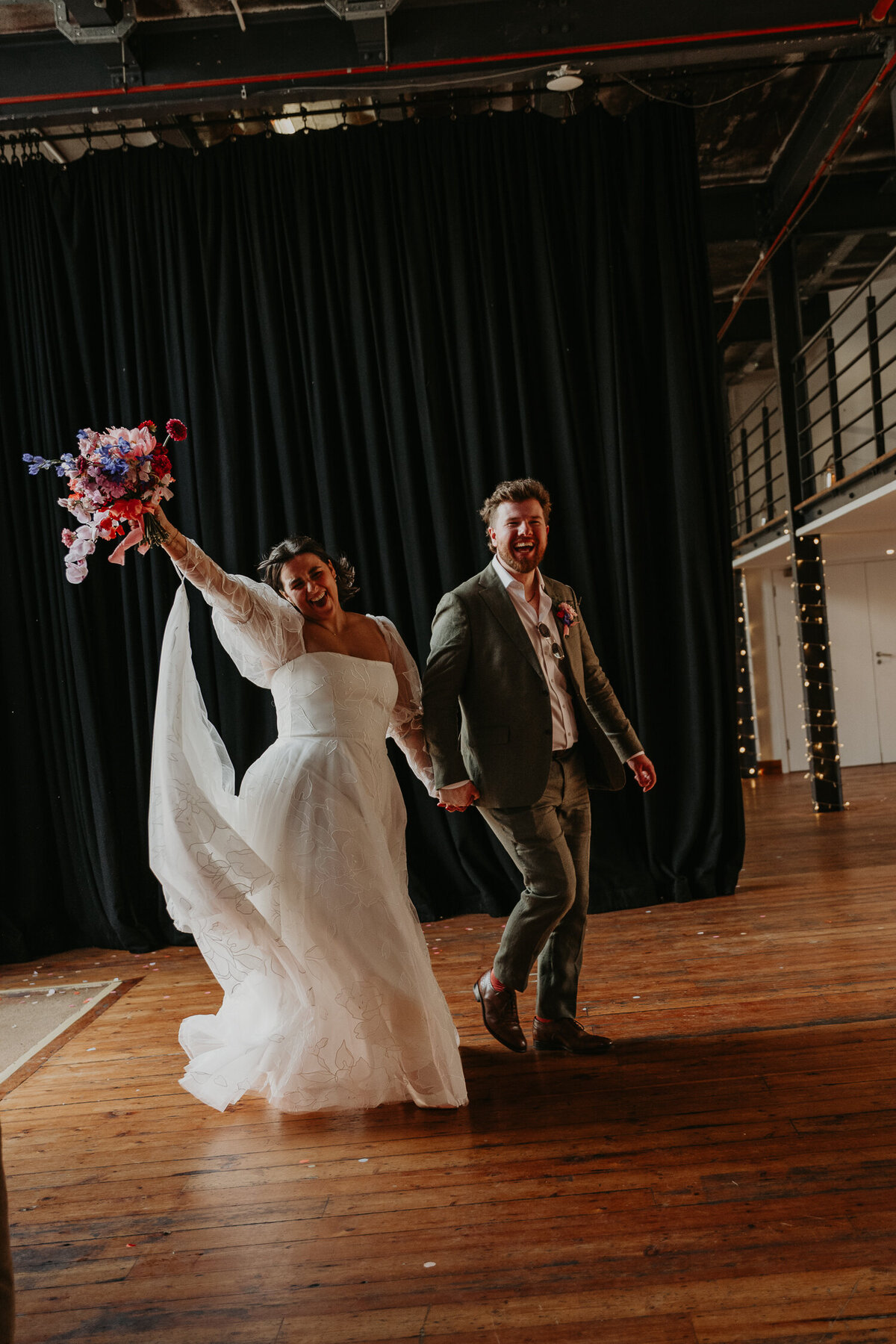 Bride and Groom enter Paintworks in Bristol to their wedding breakfast. 