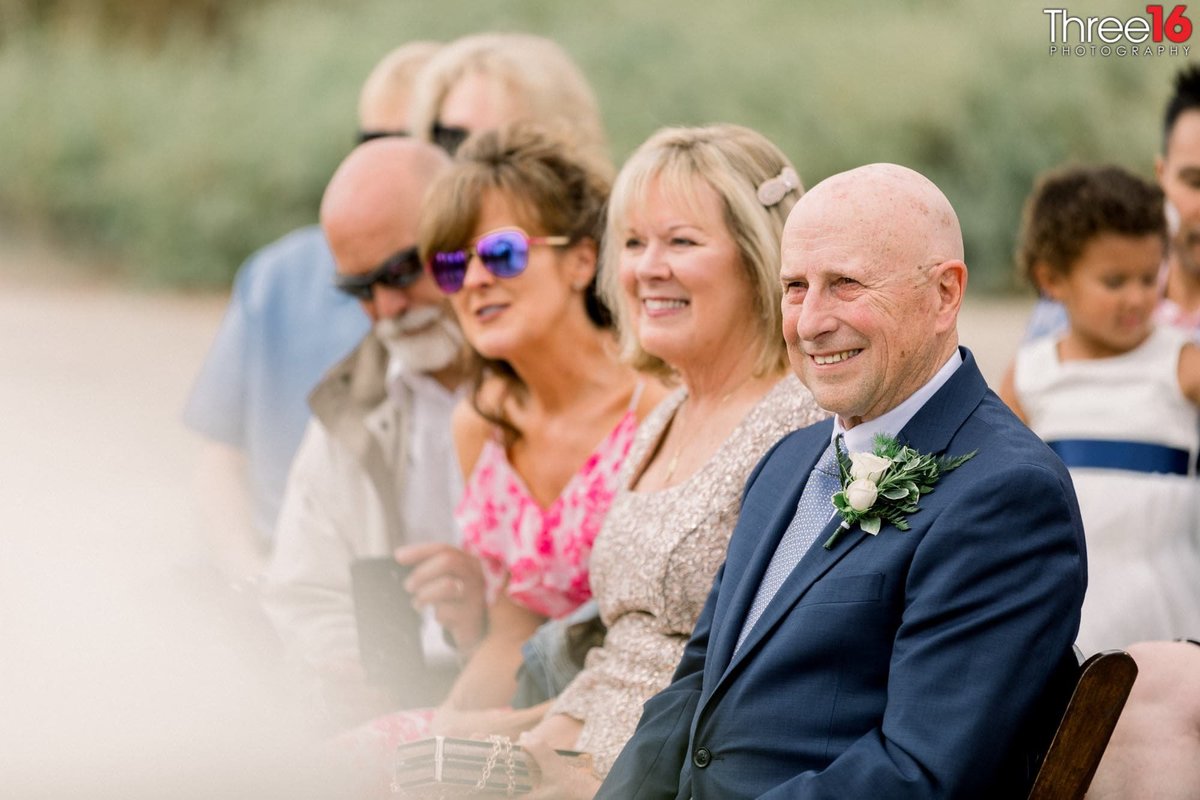 Family shares a smile during the wedding ceremony