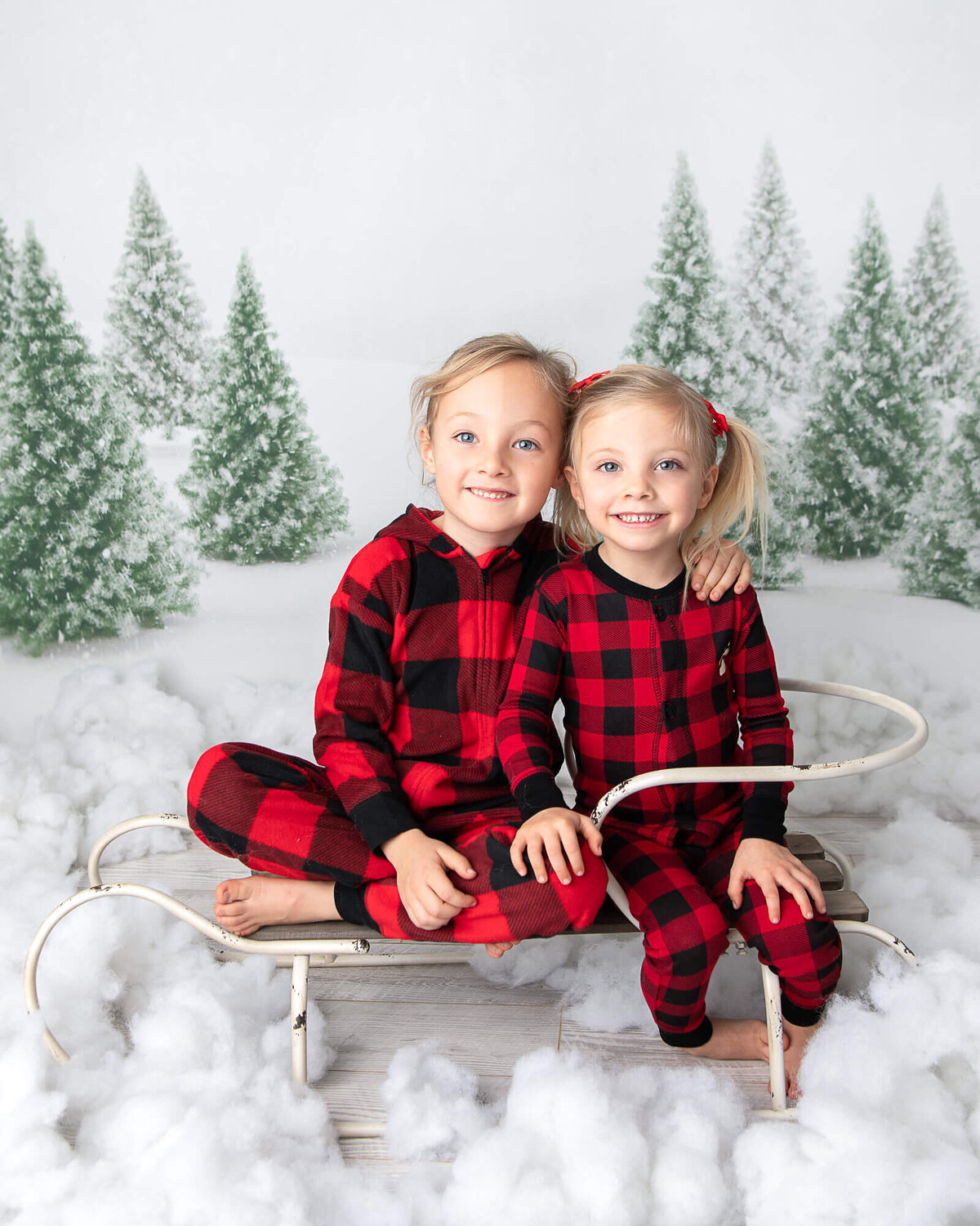 christmas card picture, boy and girl sitting on a sled