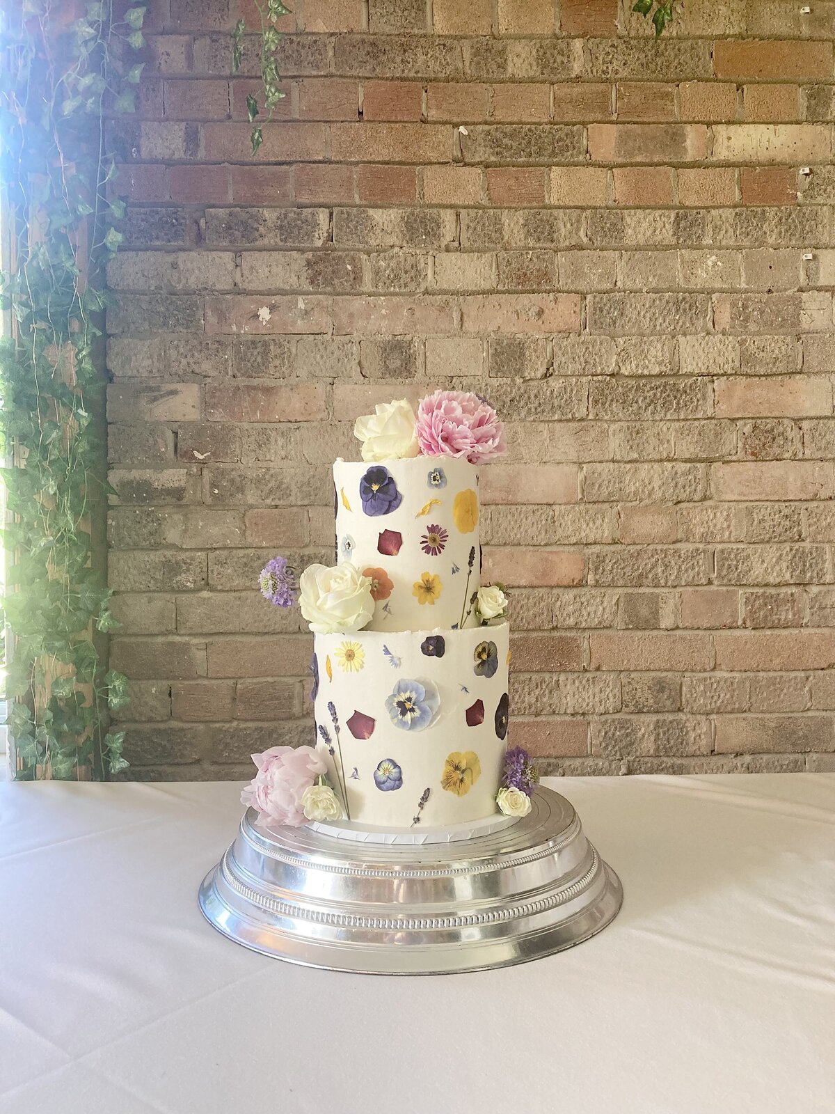 Mix of edible and fresh flower wedding cake
