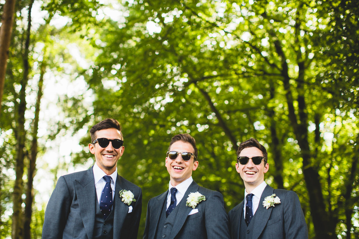 groom and best men in ray bans