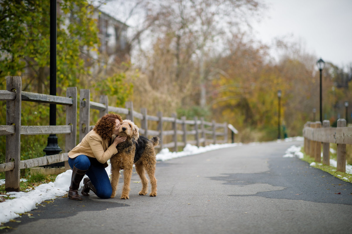 airedale gets kiss from mom at portrait session