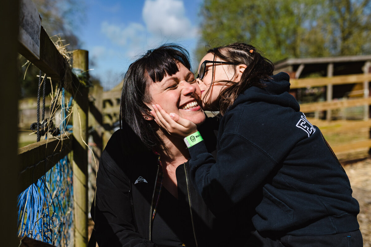 Little girl kissing her mum at rutland farm park