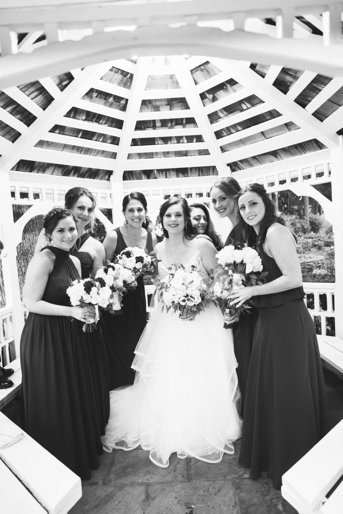 Bridesmaids photo with the bride at the gazebo of Fox Hollow