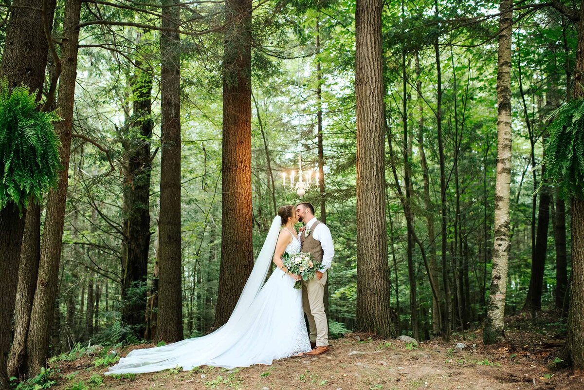 vermont woodsy wedding in the forest under a chandelier