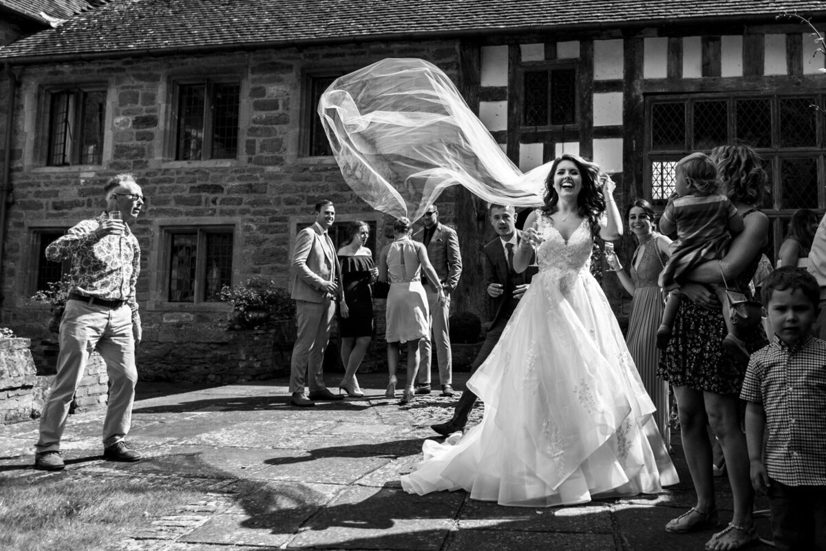 bride having veil flowing in wind