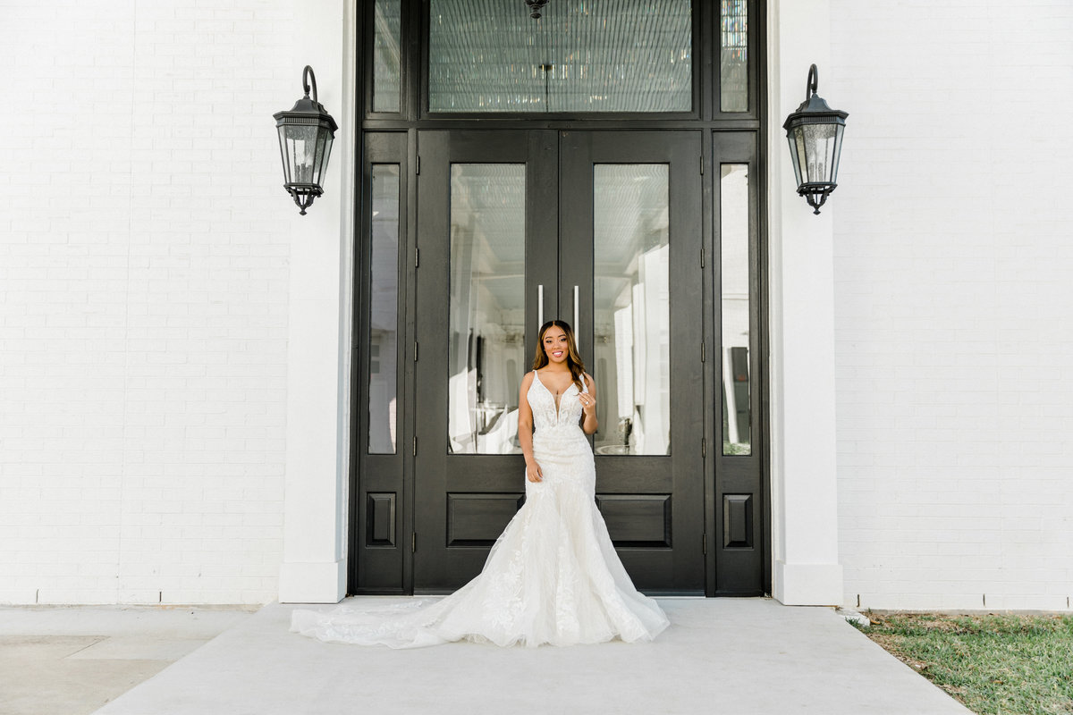 bride at sandlewood manor in front of doorss