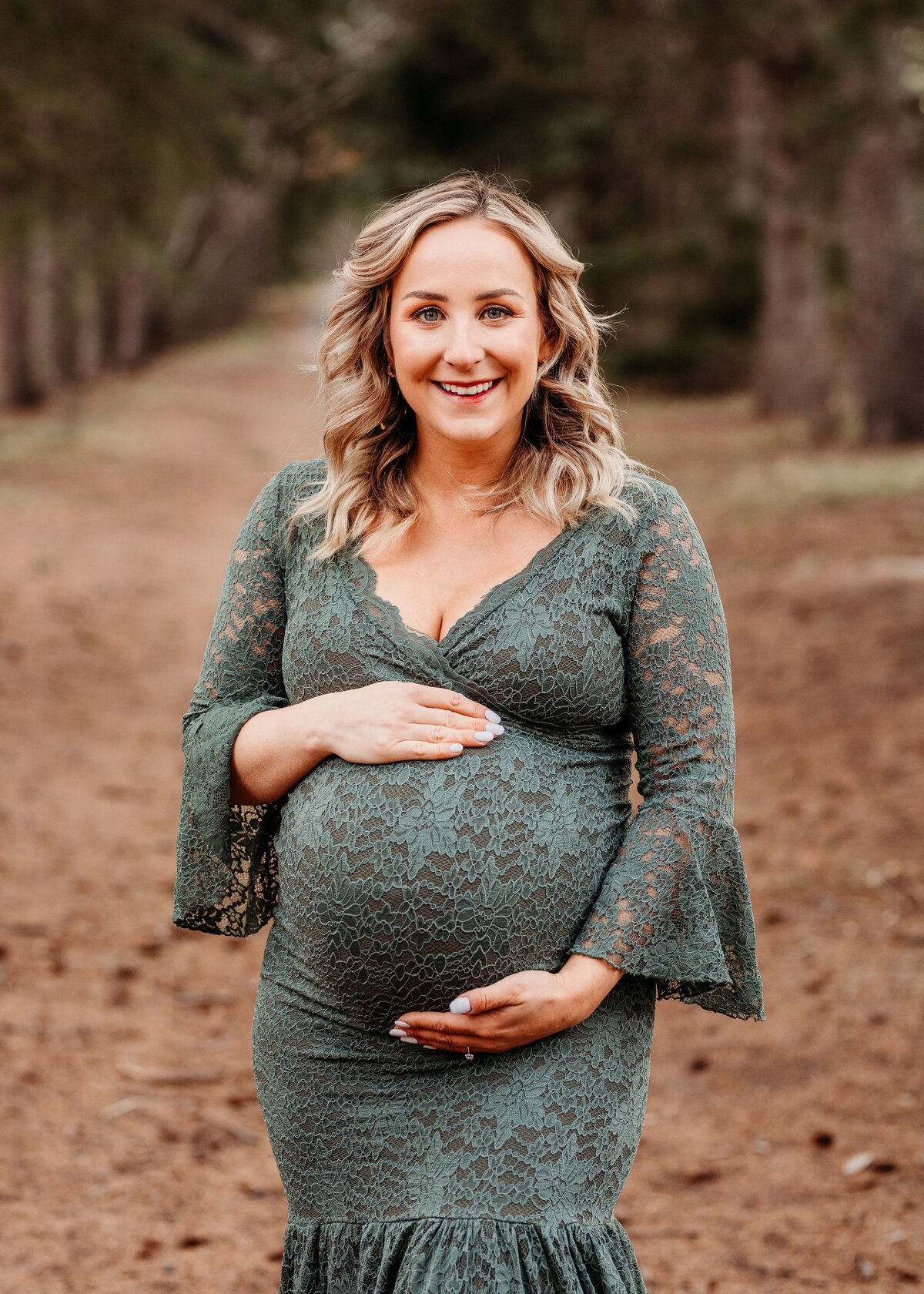 Pregnant woman in sage lace gown