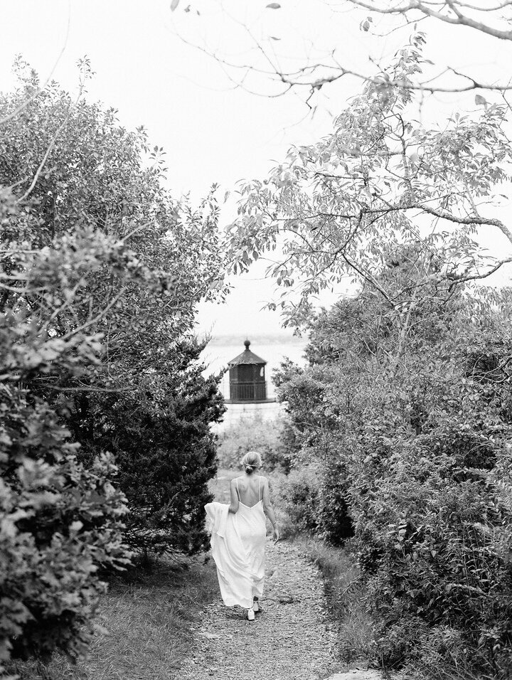 bride walking at castle hill lighthouse in newport rhode island