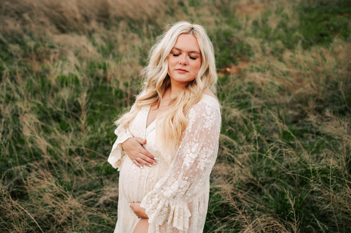blonde pregnant mom in lace dress in a field in Springfield MO