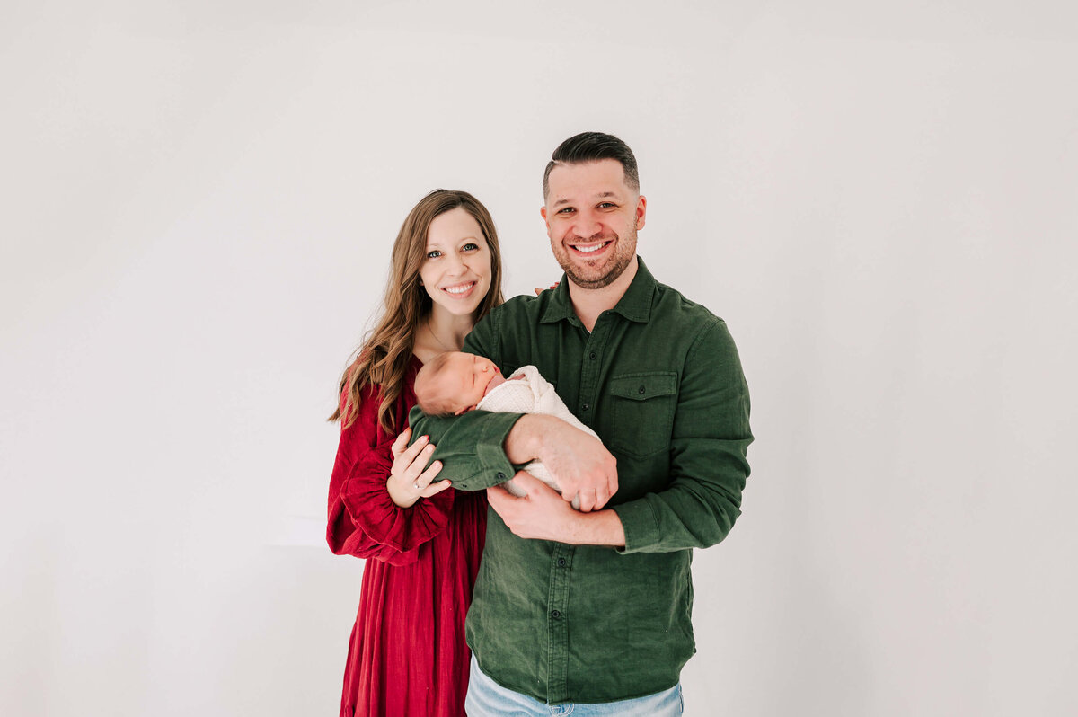 Springfield MO newborn photography of mom and dad smiling holding baby