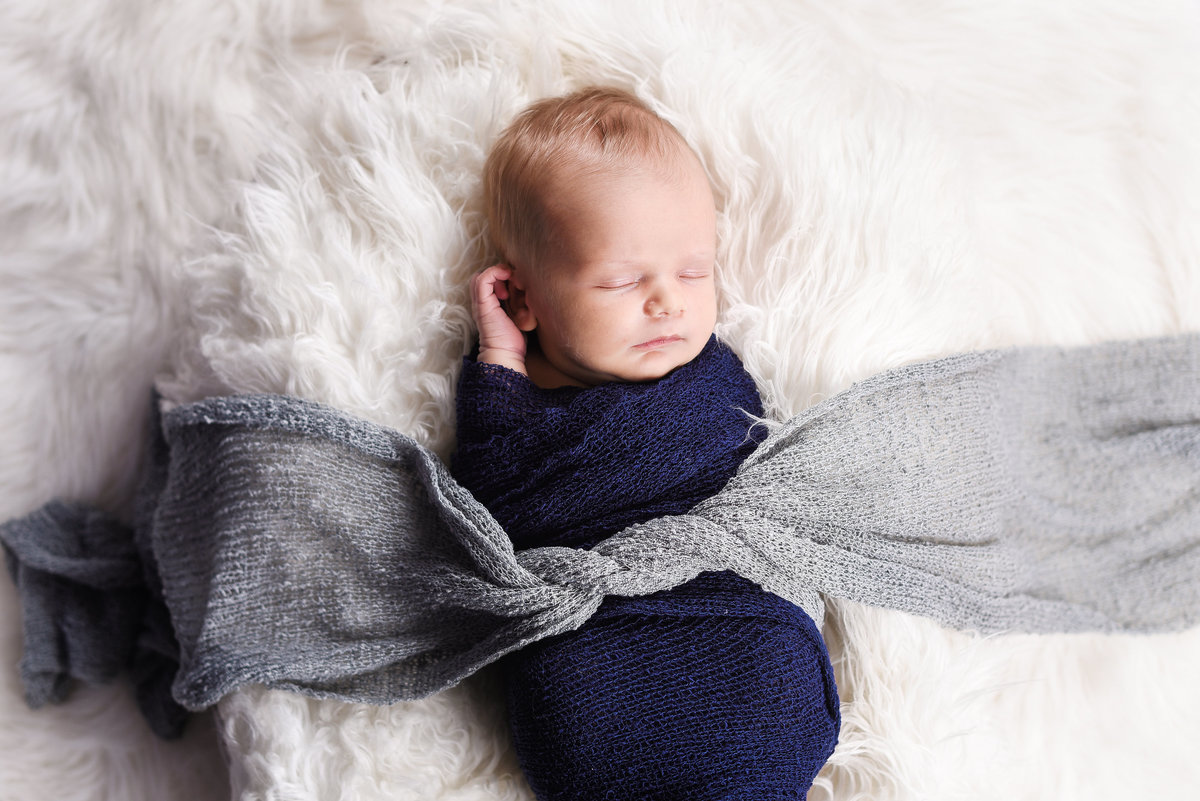Beautiful Mississippi Newborn Photography: newborn boy wrapped in navy and baby blue