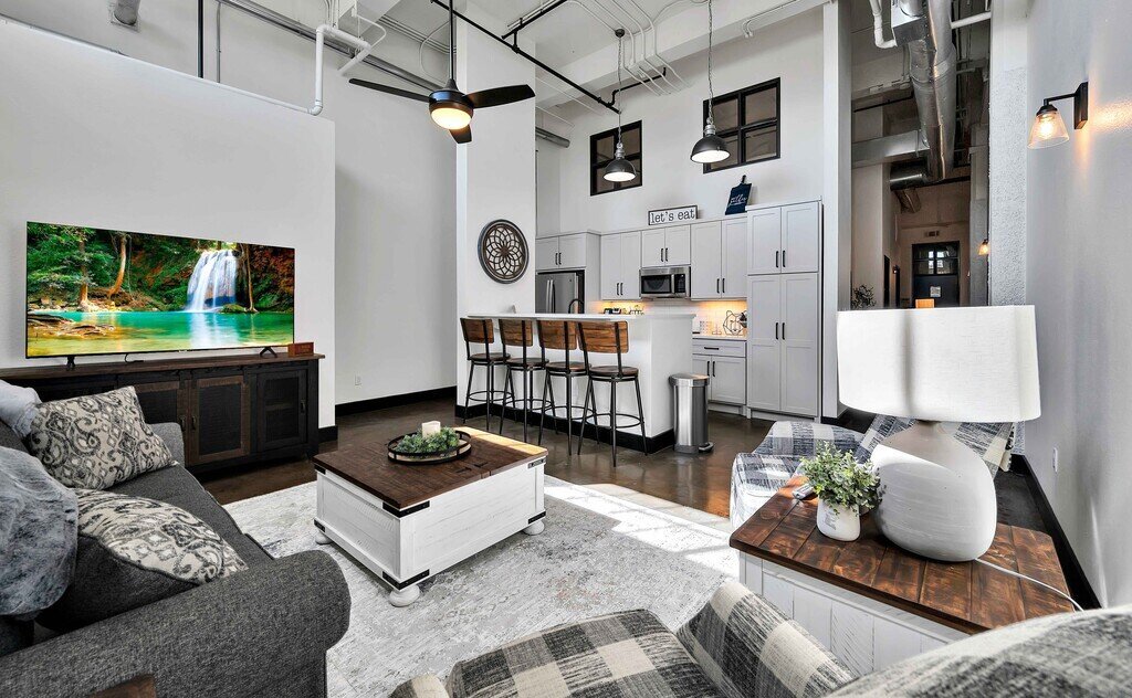 Living area of this industrial two-bedroom, two-bathroom first floor rental condo in the historic Behrens Building in downtown Waco, TX.